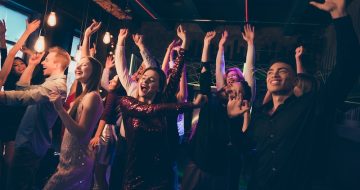 Crowd of cheerful company students want celebrate university high-school graduation go nightclub enjoy fest dance party like wild wearing formalwear dress skirt in discotheque
